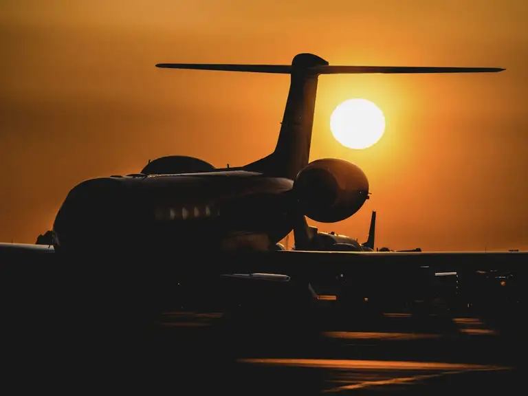 A jet silhouetted at sunset.