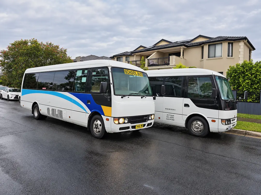 Minibuses, one with a school bus sign.